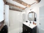 Main level bathroom has a new shower for 2023 and plenty of storage space